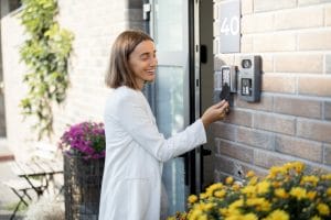 Woman unlocking a door with a key card - The best Business Security Systems for Property Managers