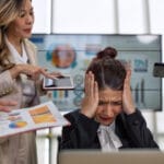 Image of a stressed business owner with her head in her hands to reresent business continuity and crisis management
