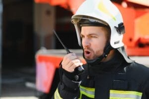 Crisis communication in action standing near a firetruck. Emergency safety. Protection, rescue from danger.